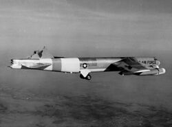 Black-and-white photo of a B-52 in flight with its vertical stabilizer sheared off.
