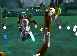 In a swamp-themed setting, a young man holds a futuristic sword-like weapon, apparently about to kill a large snake made of small plastic toy pieces. A short, somewhat cylindrical-shaped white and blue robot stands in the background. Visible in the foreground and background are many small disc-shaped objects; most of them are silver but some are gold or blue.