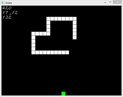 snake made of white squares going towards an apple represented by a green square - the score and other data are at the top right in white