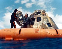A navy diver helps Ed Mitchell into the recovery raft Ap14-S71-19474.jpg