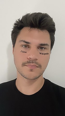 A selfie taken by a man using an "I love Wikipedia" filter.jpg