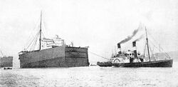 SS Suevic bow being towed.jpg