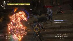 A dark-clothed man summons a great stone fist to damage a group of enemies, with his companion dog attacking one in front of him. Game HUD elements are displayed including health bar and ability commands.