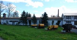 Four piecs of historic narrow gauge rolling stock from 1910-1970 displayed in front of the head quarters