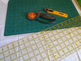 Rotary cutter on a mat being used for sewing and cutting purposes
