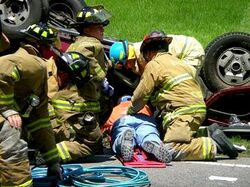 Volunteer firefighters treat a car wreck victim.jpg