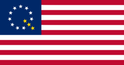 A modified version of the American flag with ten white stars and three gold stars forming a letter Q in the canton