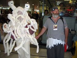 A man dressed in pirate regalia standing next to a person costumed as the Flying Spaghetti Monster.