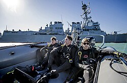 Petty Officers ride in a rigid-hull inflatable boat as they approach the USS Mason. (31494897982).jpg