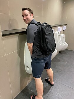 A man using a urinal.jpg