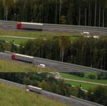 A car passes a slower moving truck, using a passing lane on the A2 motorway in Slovenia