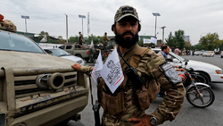 Taliban member with chest flags.png