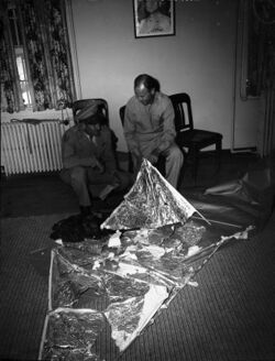 Ramey and Dubose with torn foil and sticks on packing paper
