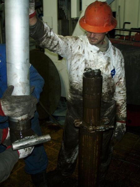 File:Pulling the Bakken Core out of the core barrell.JPG