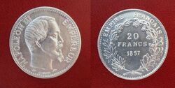 Front and back of a shiny silver coin, front with the picture of a bearded man; back with the value and date surrounded by a wreath of leaves