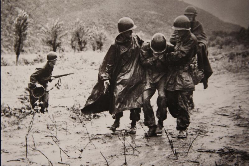 File:In this undated file photo, U.S. Army Capt. Emil Kapaun, right, a chaplain with the 3rd Battalion, 8th Cavalry Regiment, 1st Cavalry Division, helps a Soldier carry an exhausted troop off the battlefield 130311-A-CP123-001.jpg