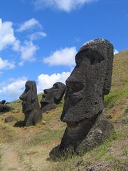 Stone statues of human heads and torsos