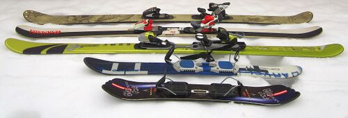 Twintip skis (back to front: backcountry ski, park ski with wood core, park ski with foam core, skiboards