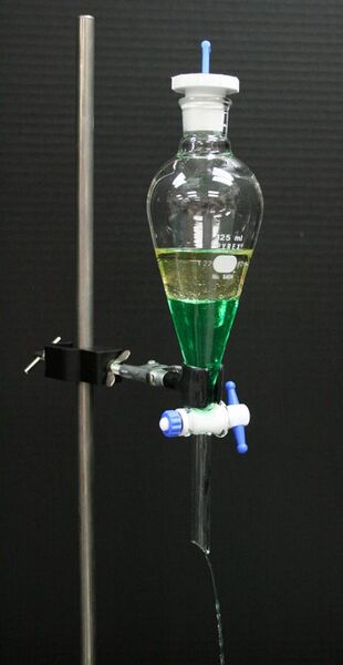 File:Separatory funnel with oil and colored water.jpg