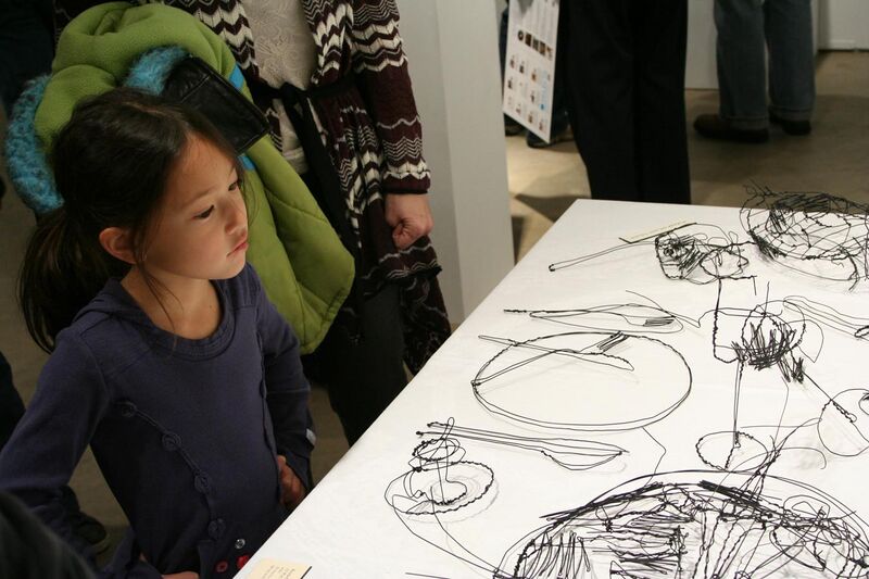 File:Girl looks at Wire Scribble Sculpture.jpg