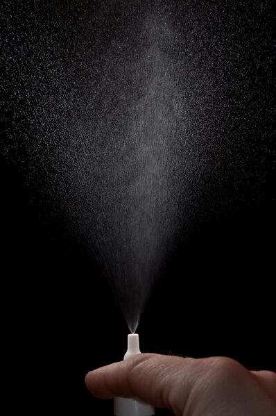 File:Action photo of nasal spray on a black background.jpg