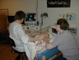 Sonographer doing pediatric echocardiography.JPG