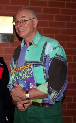Kruszelnicki holding a copy of his book Sensational Moments in Science