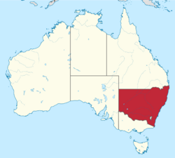 A white map of Australia with a red region for New South Wales