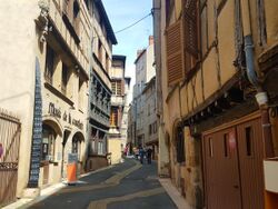 Photograph of a street bordered on both sides by buildings.