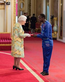 Biddemu Bazil Mwotta Receiving the Award from the Queen at the Queen's Young Leaders Awards.jpg