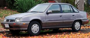 1992 Pontiac LeMans SE Sedan in Grey, Front Left.jpg