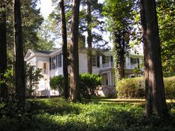 A white house set among trees