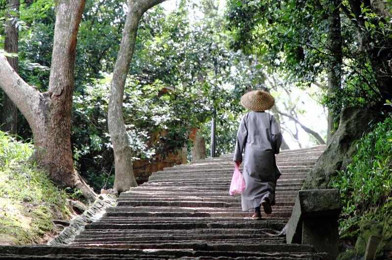 File:A Chinese nun climbing ascending steps on Mount Putuo Shan island.JPG
