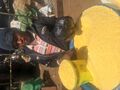 A young man at an outdoor market stall sells a kind of flour made from cassava called garri