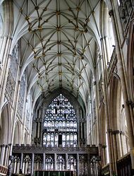 This interior view at York shows the Gothic style becoming less about projecting forms and more about surface treatment. The walls, vault and east window are all covered with a decorative net-like tracery. The pattern of the vault ribs resembles interconnecting stars.