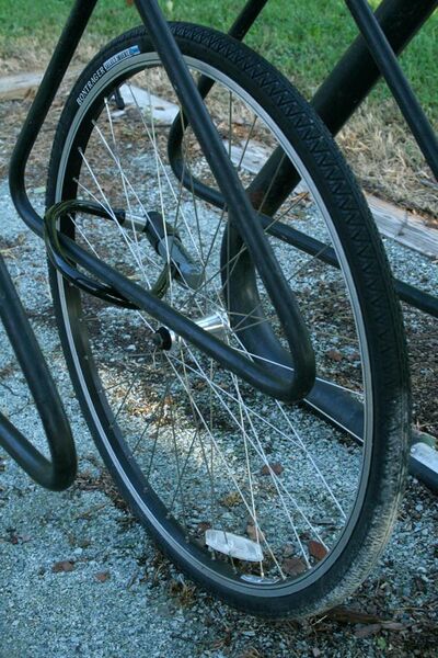 File:2008-09-06 Solitary bicycle wheel in a bike rack.jpg