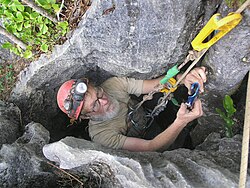 A caver approaches surface ascending on a rope using SRT ascenders