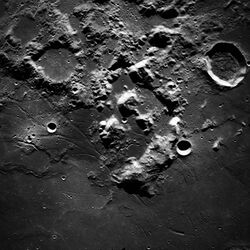 Black and white photo of a created surface of the Moon showing the landing site and surrounding area for Apollo 17 as taken from Apollo 17.