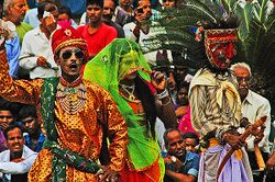 Bhanjara gypsy trader boasting while wife and Budia figure shrug