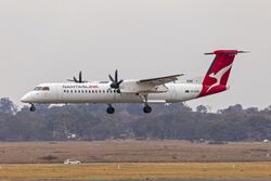 QantasLink (VH-QOM) Bombardier DHC-8-402Q landing at Canberra Airport (1).jpg