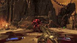Screenshot from Doom showing the player fighting a Baron of Hell with the Super Shotgun