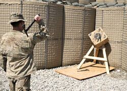 U.S. Army Spc. Kirk Calabrese with Bravo Company, 2nd Battalion, 23rd Infantry Regiment throws a tomahawk.jpg