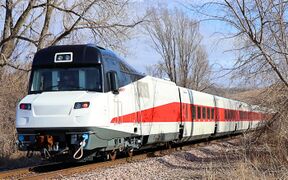 A white passenger trainset with a red window stripe and black cab roof