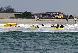 US Navy 070412-N-9604C-005 Rescue swimmers wrestle with a rip tide during the kayaking event at the annual Naval Helicopter Aviation (NHA) Symposium 2007 Aircrew Competition.jpg