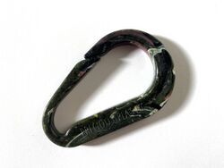 A recycled plastic carabiner made with Precious Plastic machinery
