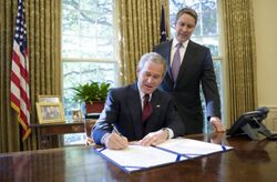 With Sen. Bill Frist (R-Tenn.) looking on, President George W. Bush signs into law S-3728, the North Korea Nonproliferation Act of 2006, Friday, Oct. 13, 2006, in the Oval Office.jpg