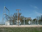 An image of an unconcealed substation in Warren, Minnesota with many metal parts fenced off in an open field.