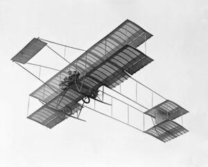 Louis Paulhan flying with a passenger (Mrs. Dick Ferris?) in his Henry Farman biplane, at the Dominguez Field Air Meet, Los Angeles, January 1910 (CHS-5602).jpg