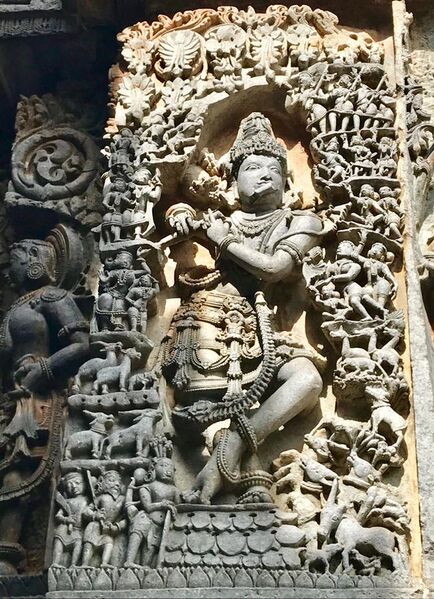 File:12th-century Krishna playing flute with gathered living beings lost in music at Shaivism Hindu temple Hoysaleswara arts Halebidu Karnataka India.jpg