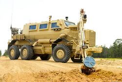 A U.S. Army Buffalo explosive device detection vehicle, assigned to 1221st Route Clearance Company, South Carolina Army National Guard, digs up an improvised explosive device (IED) during route clearance 140624-Z-XH297-029.jpg